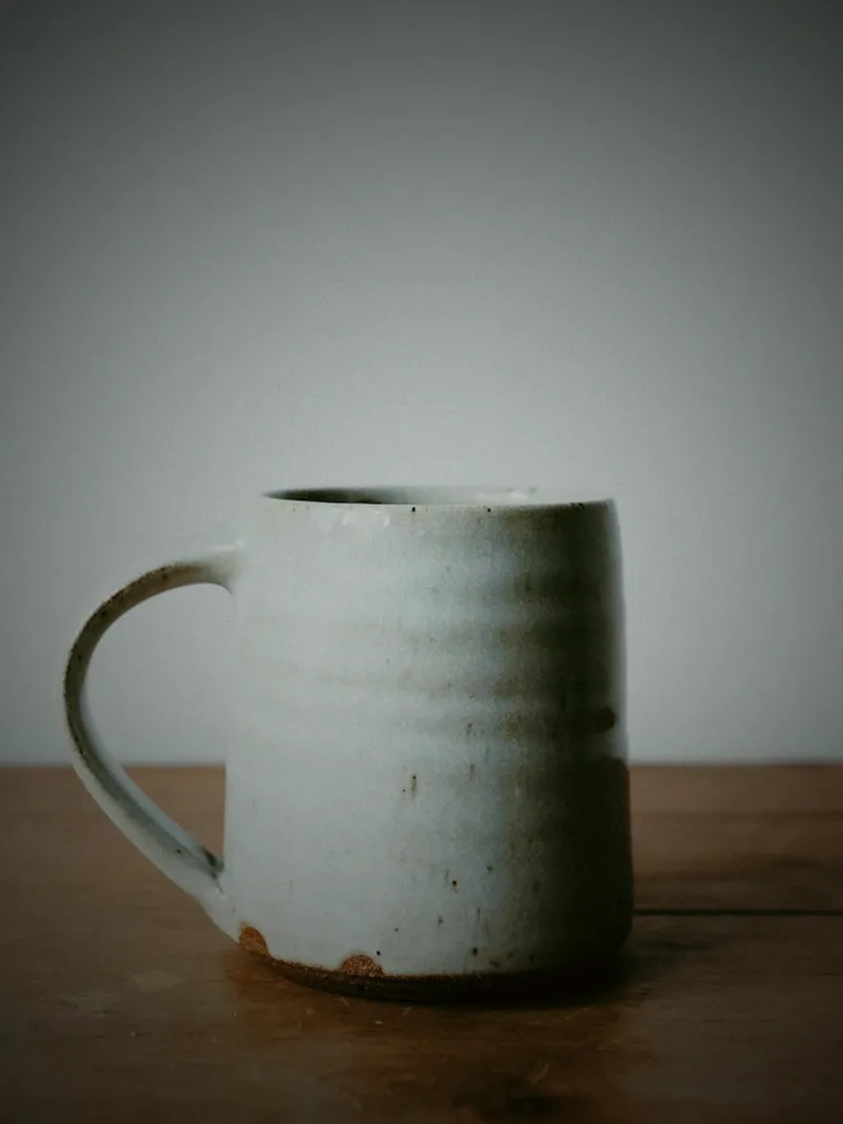 A phone photo of a mug on a kitchen counter.